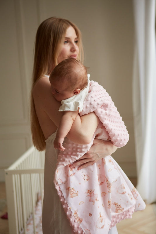 Baby cocoon blanket made from soft minky fabric, part of the Bunnyland collection, captured from a side-angle view