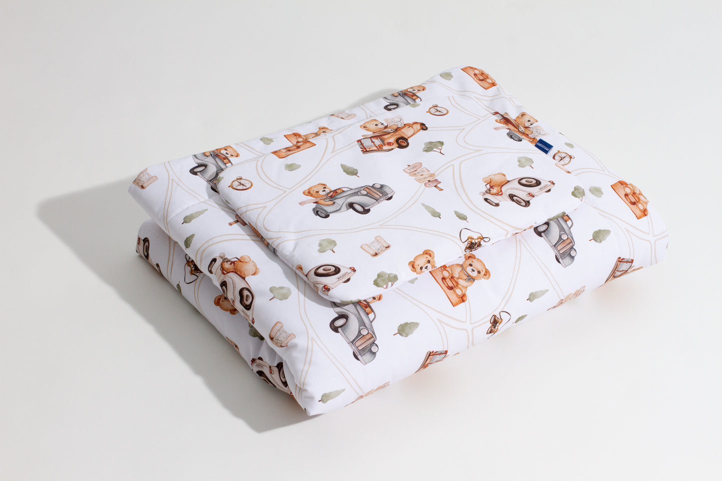 Baby bedding “Road Trip” with a design of teddy bears and cars, folded neatly, made from 100% cotton