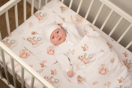 Baby bedding set Ready-to-Sleep with Moony Dream print, made from 100% cotton, featuring pastel bunnies and clouds, folded on a white surface