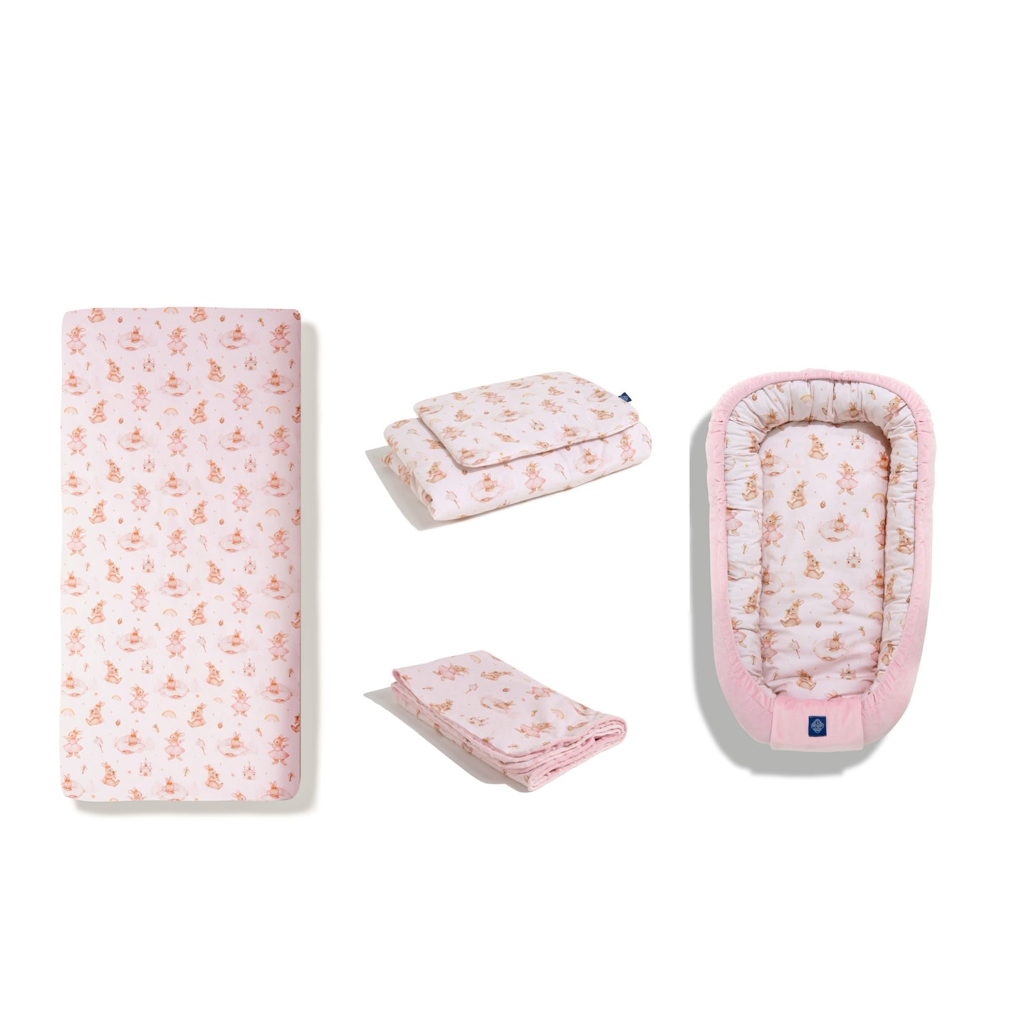 Baby bedding set in ‘Bunny Land’ print, featuring fitted sheet, duvet cover, blanket, and baby nest. Top-down view of the set